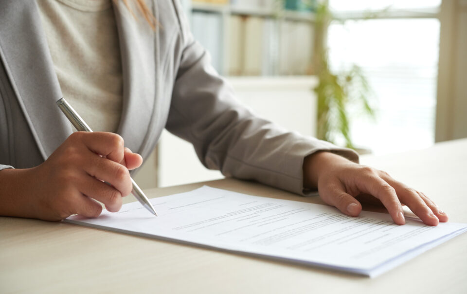 cropped mid section of unrecognizable woman signing the document 1