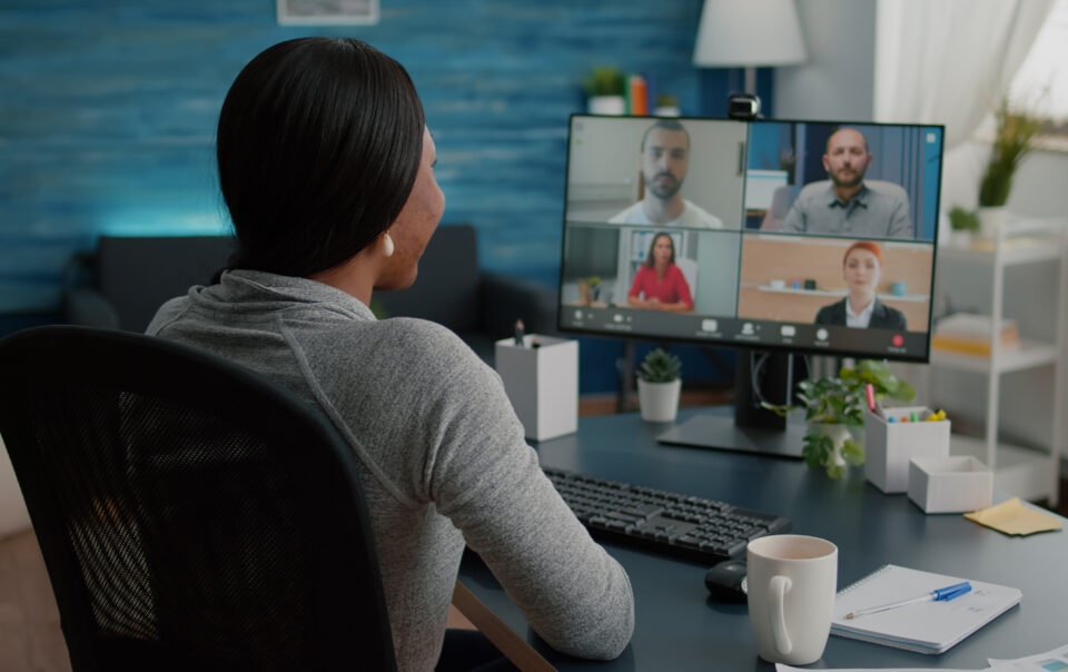 black student discussing marketing academic ideas with college team having virtual teleconference meeting sitting desk living room