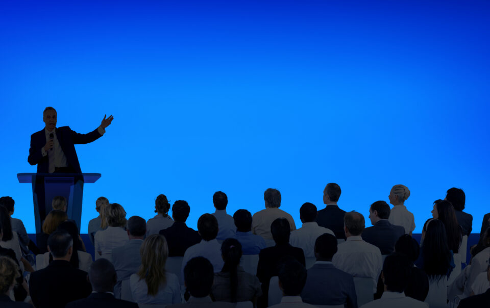 corporate businessman giving presentation large audience