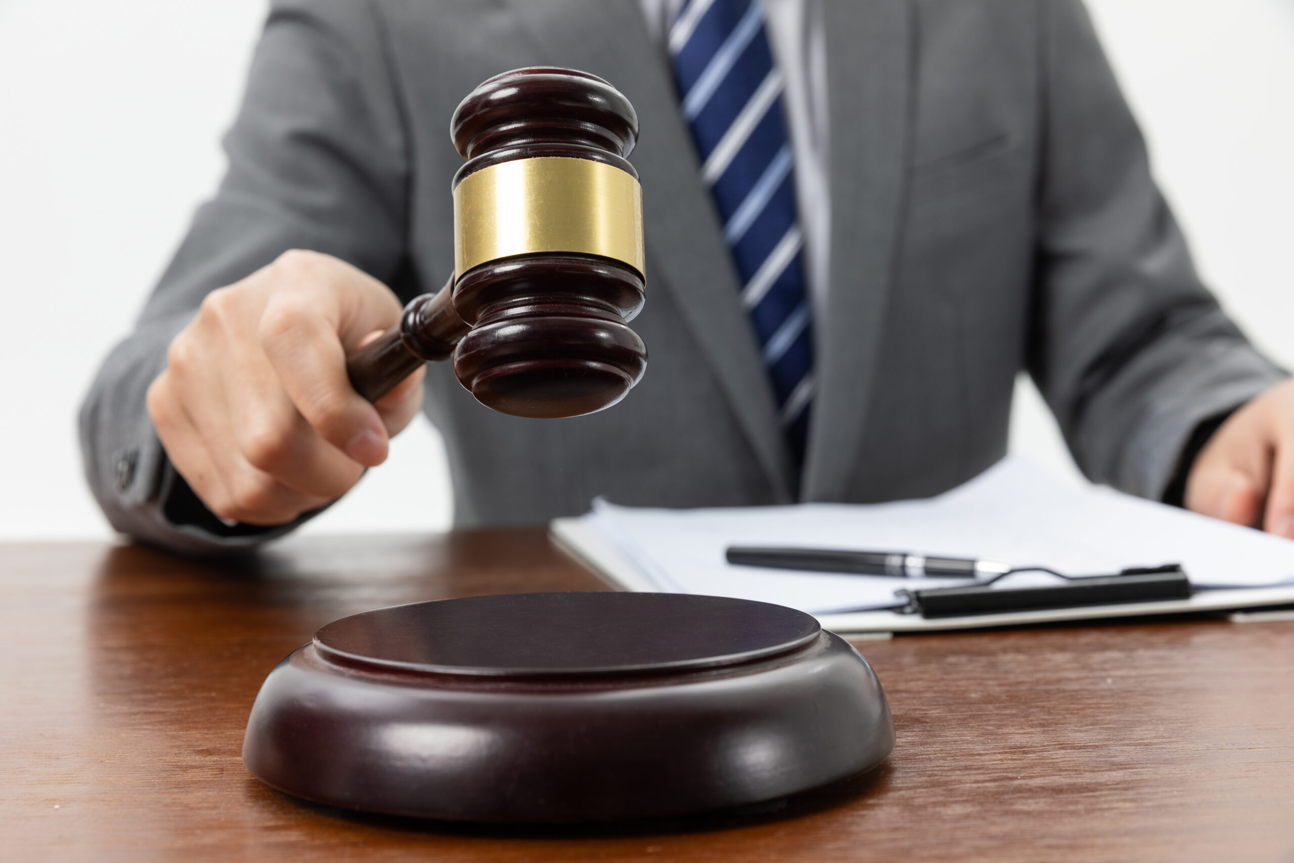 closeup shot person holding gavel tabl scaled