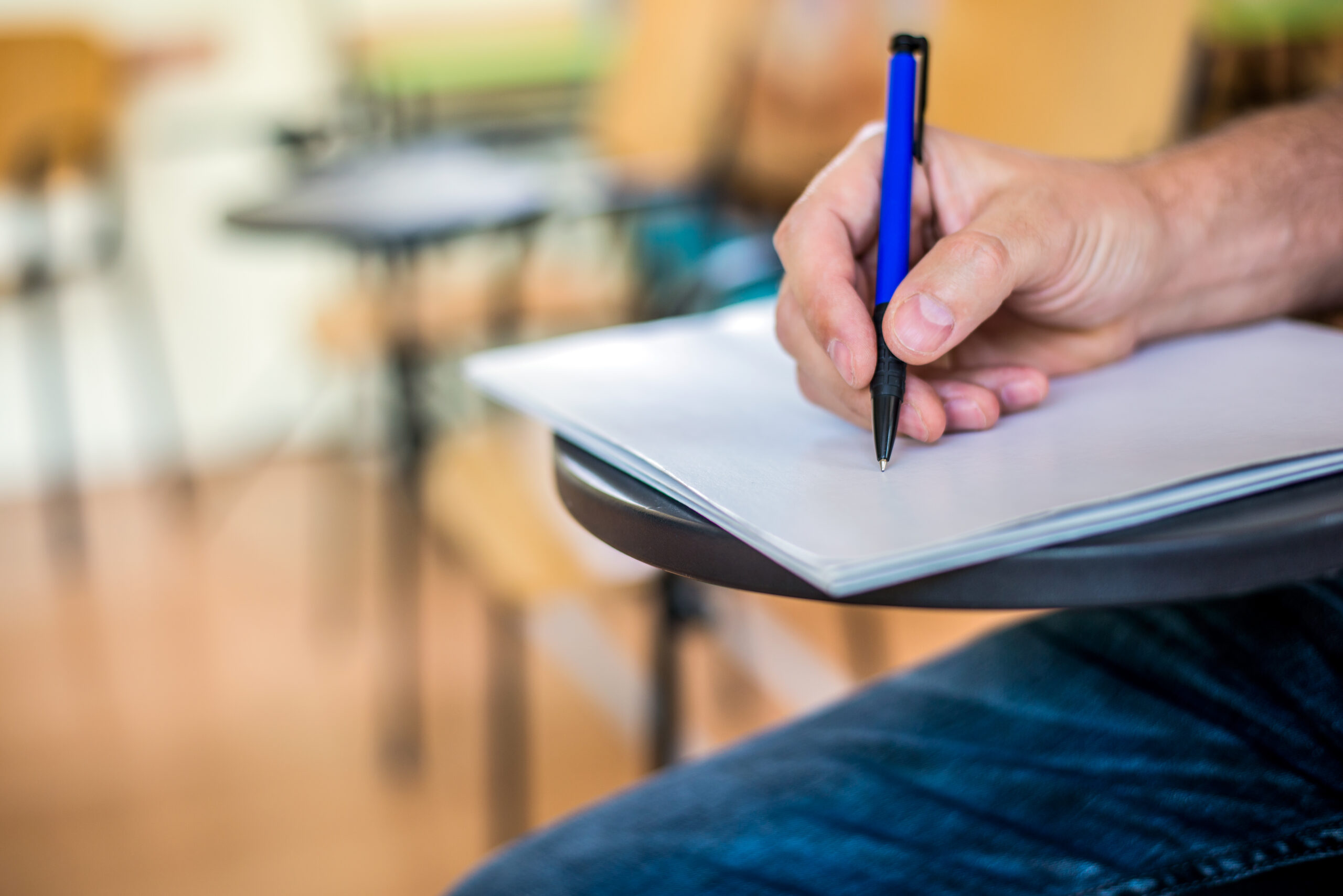 man is writing signing paper focused hand with pen scaled