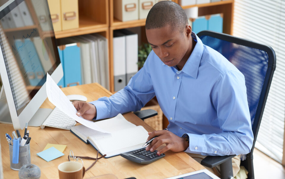 high angle view of male accountant checking financial document 1