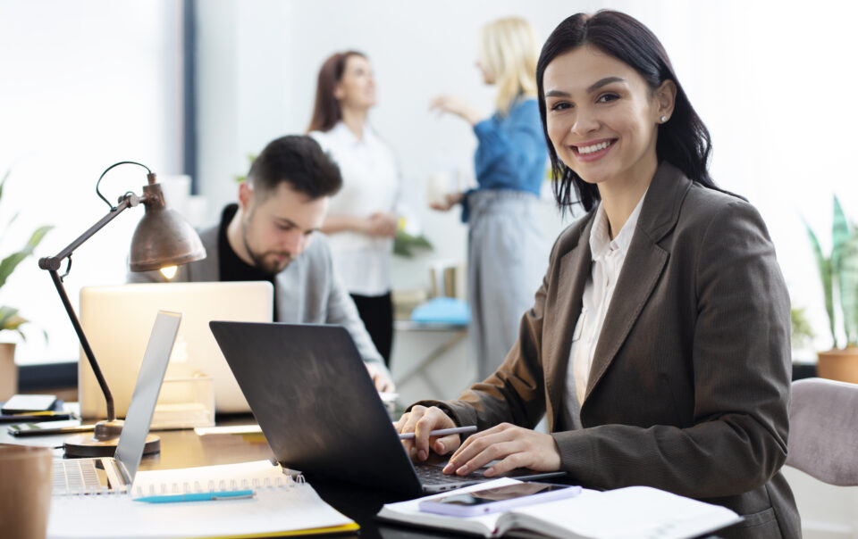 medium shot woman working on laptop