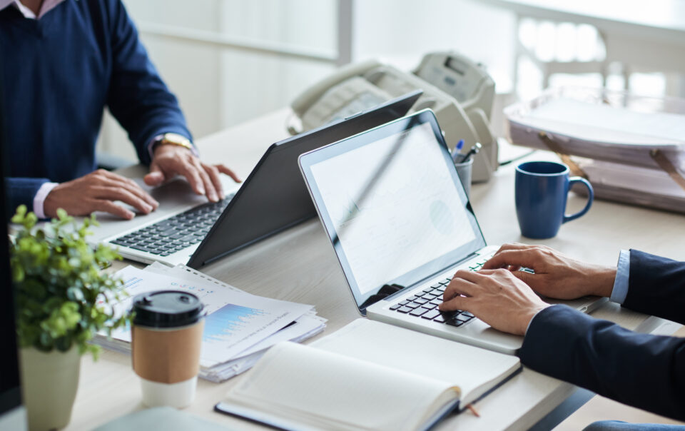 side view of cropped unrecognizable business people working at common desk