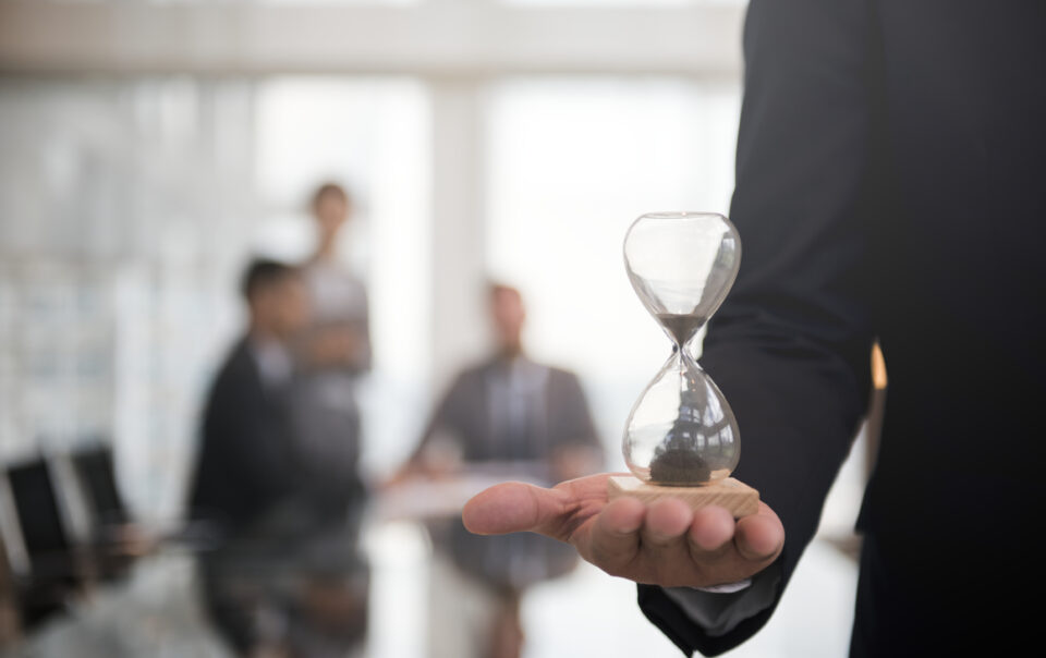 businessman holding hour glass signifies importance being time