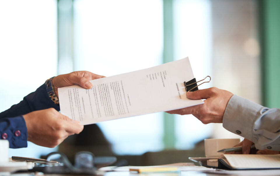 closeup hands passing contract unrecognizable businessman