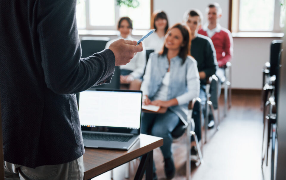 everyone is smiling listens group people business conference modern classroom daytime