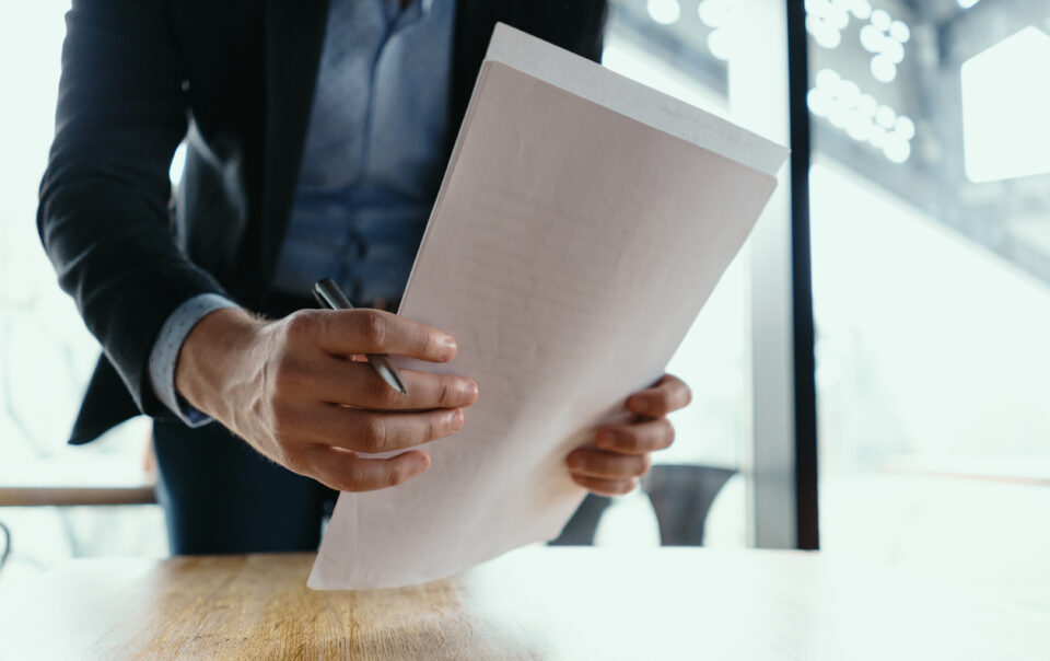 successful business man signing documents modern office