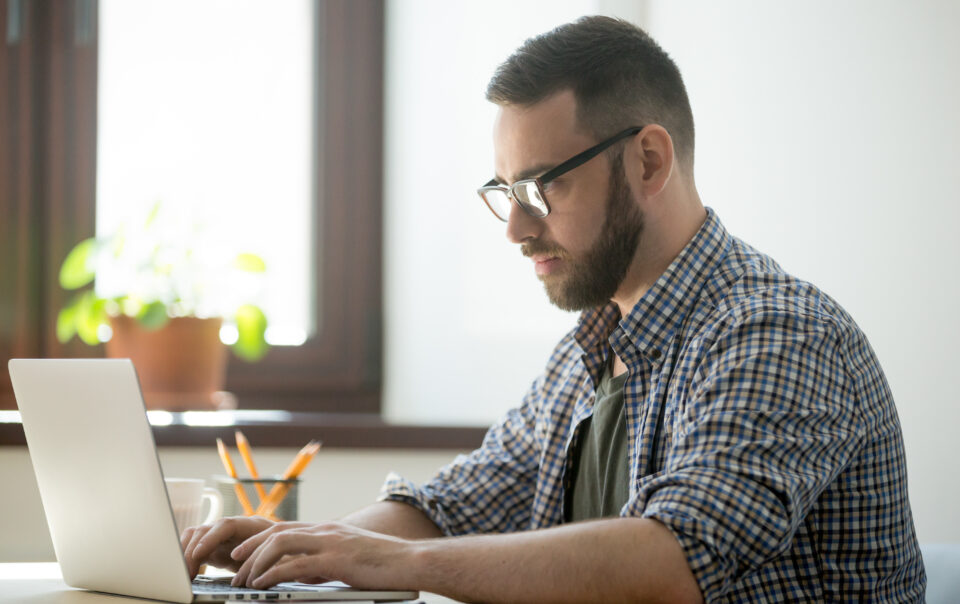 millennial generation man working laptop computer solve problem