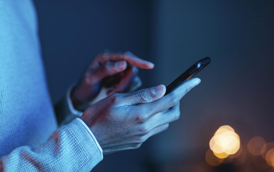 side view man using smartphone