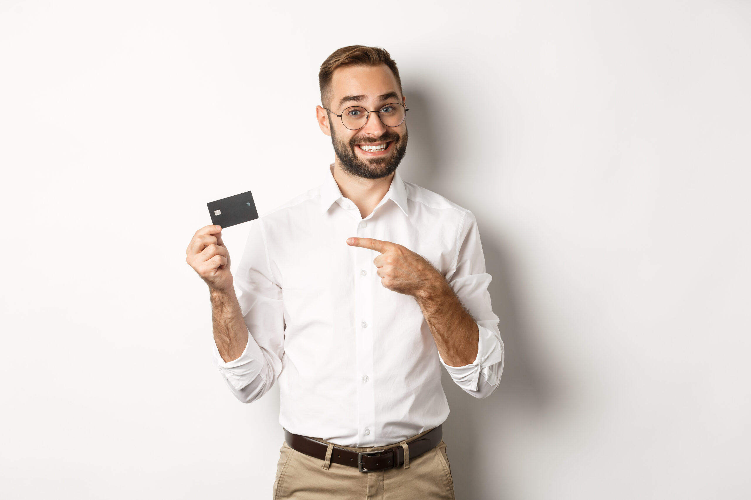 handsome satisfied man glasses pointing credit card pleased with bank services standing scaled