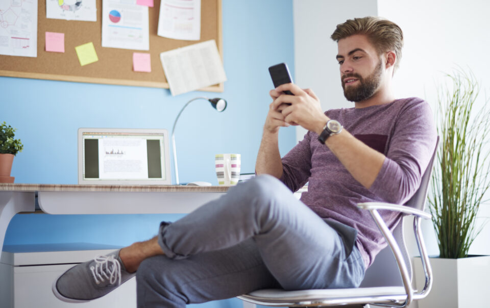 man texting with his mobilephone